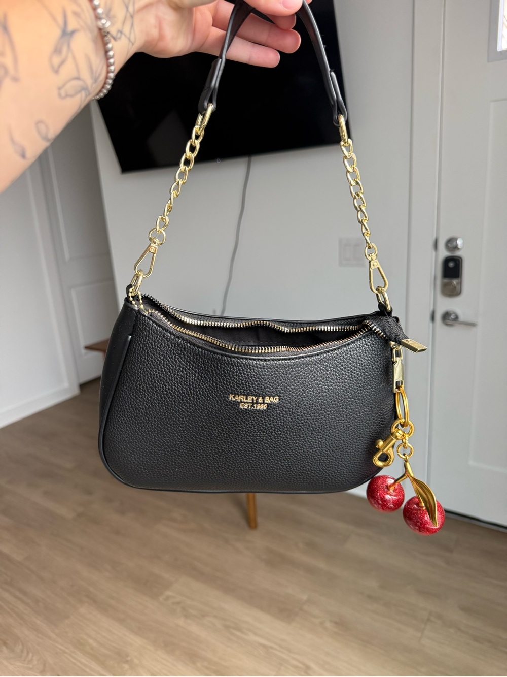 Coach Black Pebbled Leather Shoulder Bag with Red Cherry Charm